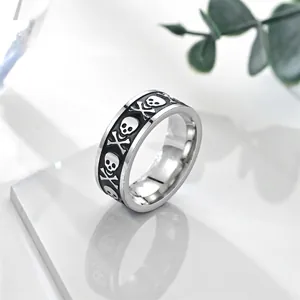Vintage stainless steel skull ring with black enamel punk patterns and silver finish