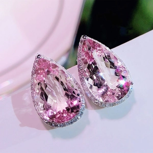 Macro shot of pear-cut pink zircon earrings with a halo of white pavé stones