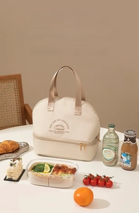 Detailed view of beige dual-layer insulated lunch bag with reinforced handles and embroidery