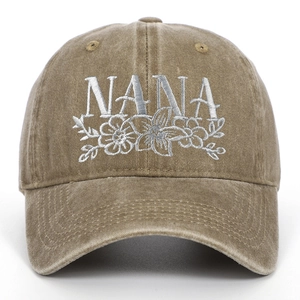 Close-up of white Nana floral embroidery on khaki washed cotton baseball cap