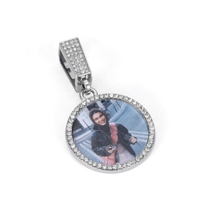 Close-up of iced out silver round photo pendant with shimmering cubic zirconia settings