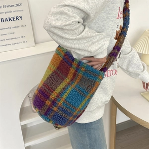 Close-up of a colorful plaid plush tote bag showing the soft texture and autumn vibes