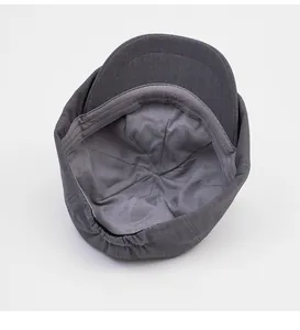 Detail view of newsboy cap interior featuring smooth grey lining and elastic adjustment strap