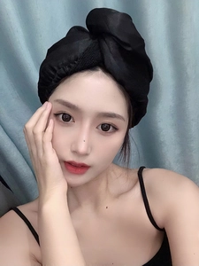 Close-up of a model wearing the black satin hair drying cap for long hair protection