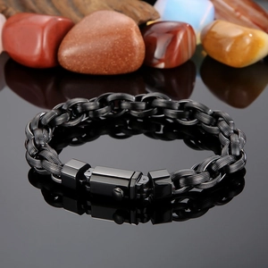 Detail of matte black men's woven chain bracelet with a secure folding clasp
