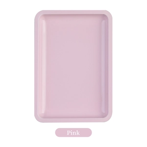 Top view of a minimalist pink rectangular metal tray with rounded corners on white background
