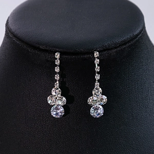 Detailed close-up of zircon flower earrings with sparkling water drop rhinestones