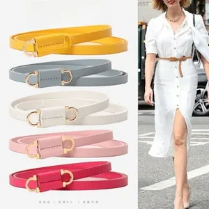 Detail showing various colors of PU leather belts with golden double crescent buckles