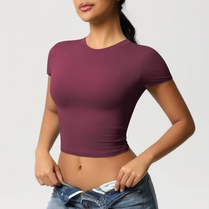 Detail of slim-fit burgundy sports crop top with breathable fabric and classic crew neck