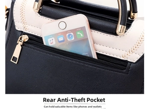 Close-up of the anti-theft back zipper pocket on a stylish black and white tote bag