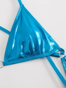 Detail of bright blue metallic swimsuit fabric with glossy finish and silver ring connector