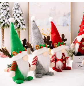 Three festive Christmas gnomes with reindeer antlers and holly leaves on colorful hats