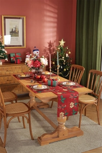 Detail of red festive Christmas table runner with holly and candy cane patterns