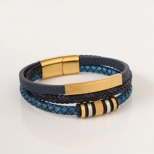 Macro shot of multi-layer blue braided leather bracelet with gold magnetic clasp