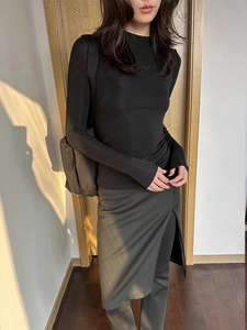 Slim fit wool tencel long sleeve top paired with a chic side slit skirt in natural sunlight