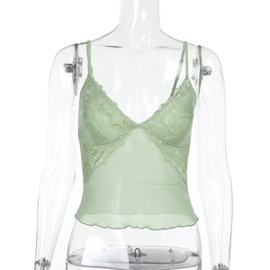 Close-up of light green lace and mesh camisole with delicate ruffle hem and V-neck