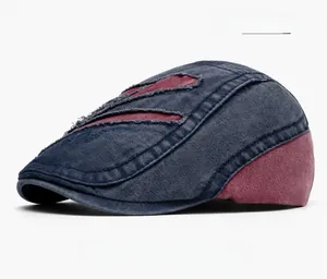 Close-up of Boston embroidery on a navy blue washed denim flat cap with red patch