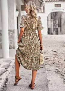 Back view of a green floral V-neck midi dress featuring short sleeves and an A-line silhouette