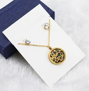 Detailed view of stainless steel hollow necklace and matching round crystal studs set