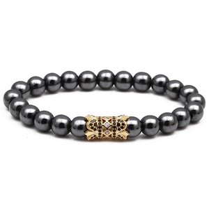 Detailed view of natural stone beaded bracelet with gold accent bead and inlaid stones