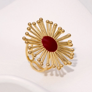Detailed macro view of vintage gold-plated stainless steel ring with red oval center
