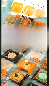 Detailed view of mooncake packaging sets with gold trays and printed sealer bags