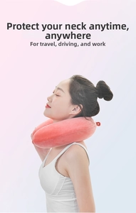 Close-up of pink memory foam U-shaped neck pillow with soft plush fabric and hanging loop