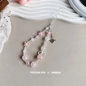 Detailed shot of pink star beads and heart lock charm on the beaded phone strap