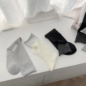 Detailed set of thin ribbed sheer socks in grey, beige, and black with shiny cuffs