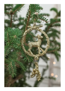 Golden glitter reindeer ornament hanging on a Christmas tree with festive lighting