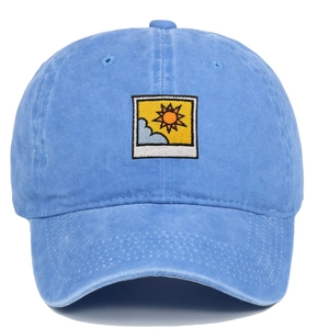 Light blue washed cotton baseball cap with artistic sun and cloud embroidery on white background