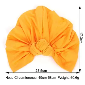 Elastic orange turban hat for women in bohemian style with knot detail and soft fabric