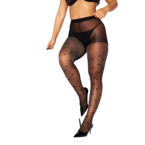 Detail of sheer black polka dot tights with silver glitter and black high heels