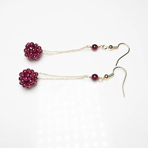 Detailed view of handmade crystal ear threads with garnet beads and 14K gold plating