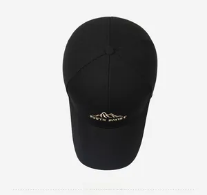 Detailed top view of black cotton baseball cap showing mountain embroidery and crown texture