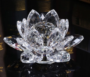 Detail of transparent crystal lotus sculpture with faceted petals reflecting light