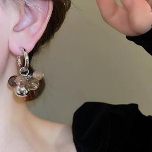 Detail view of retro gradient resin ball earrings on a model in minimalist style