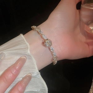 Macro shot of 14k gold plated bangle with zircon petals and rose flower detail
