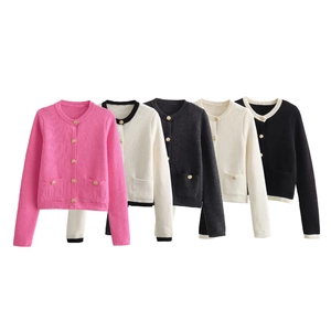 Flat lay of knit cardigans in pink, white, and grey with gold buttons and twin pockets