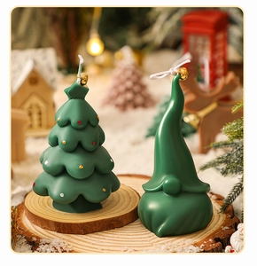 Mini green Christmas tree and gnome candles on a rustic wood slice festive display