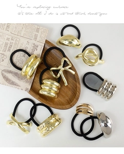 Close-up of gold and silver alloy hair ties set featuring knot and bow designs