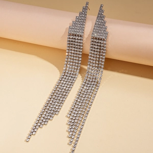 Detail of silver long tassel earrings with sparkling rhinestones in a professional studio view