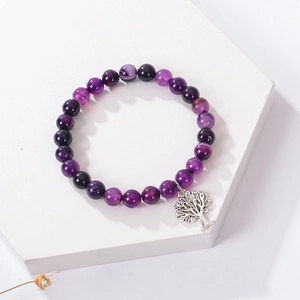 Close-up of purple striped agate beads bracelet with silver Tree of Life charm