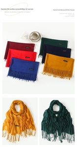 Detail of colorful cashmere feel scarves with elegant tassels and stitched fabric labels