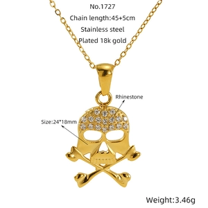 Detail of 18K gold-plated skull and crossbones pendant with white rhinestones and adjustable chain