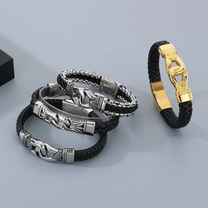 Detail of punk style braided leather bracelets with vintage pattern stainless steel clasps