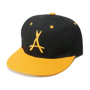 Detailed close-up of a black and yellow flat brim baseball cap with 3D letter A embroidery
