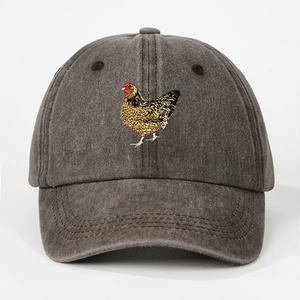 Close-up of rooster embroidery on washed cotton baseball cap with detailed stitching