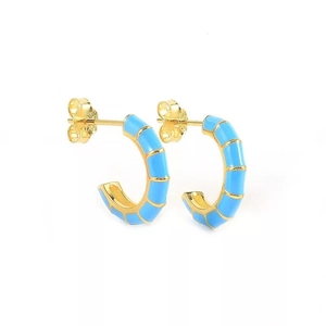 Macro view of blue enamel C-shape hoop earrings with S925 sterling silver hallmarking