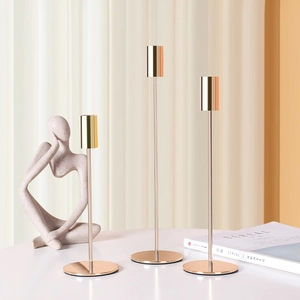 Set of three golden minimalist candle holders in varying heights for Nordic home decor